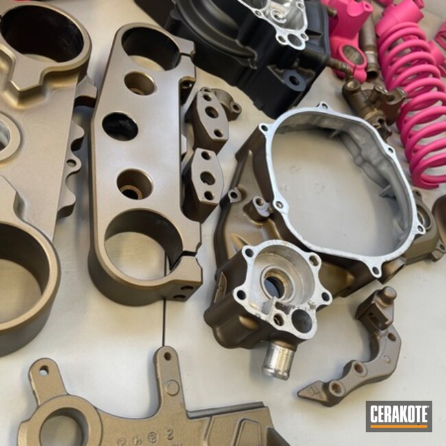 Various Automotive Parts Cerakoted In Burn Bronze, Glacier Black And Prison Pink 