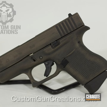 Cerakoted Glock 43 Handgun Done In A Distressed Graphite Black And Magpul Flat Dark Earth Finish