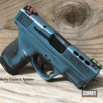 Cerakoted Distressed M&p Shield Handgun In Graphite Black And Blue Titanium
