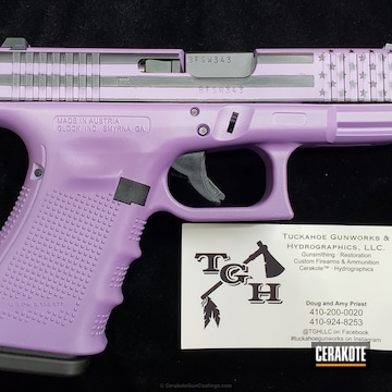 Cerakoted Glock Handgun Done In A Pastel Purple And Black American Flag Finish