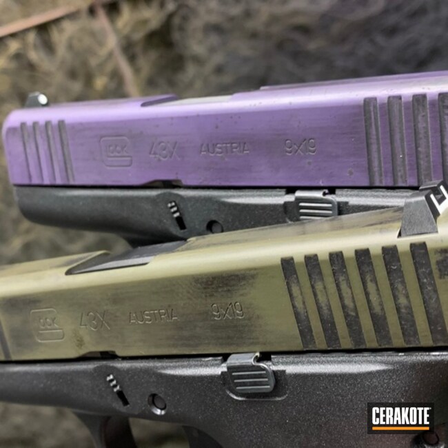 Pair Of Battleworn 43x Glocks Cerakoted Using O.d. Green, Graphite Black And Bright Purple