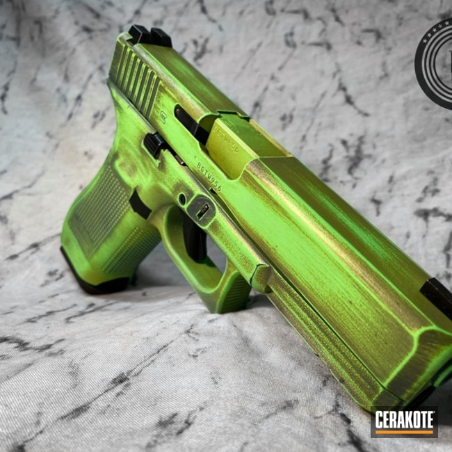 Battleworn Glock 17 Pistol Cerakoted Using Mojito, Parakeet Green And Jesse James Civil Defense Blue