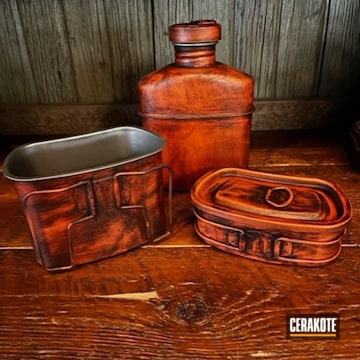 Distressed Water Canteen Cerakoted Using Hunter Orange And Graphite Black