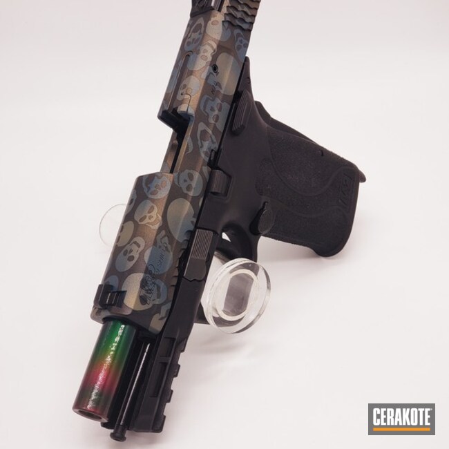 Skull Themed Smith & Wesson M&p Shield Pistol Cerakoted Using Graphite Black, Blue Titanium And Gold