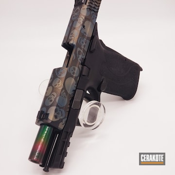 Skull Themed Smith & Wesson M&p Shield Pistol Cerakoted Using Graphite Black, Blue Titanium And Gold