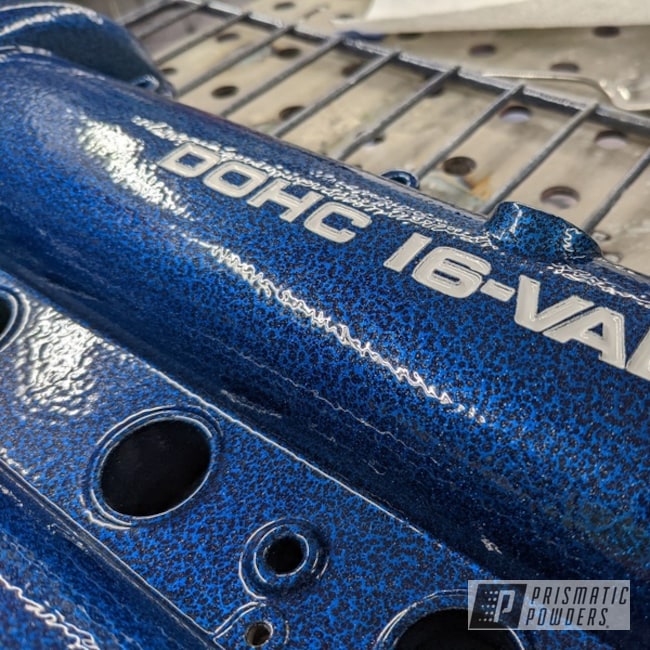 Miata Valve Cover Coated In Arctic White, Silver Artery And Booty Blue. Powder Coating Provides A Hard Finish That Is Tougher Than Conventional Paint.