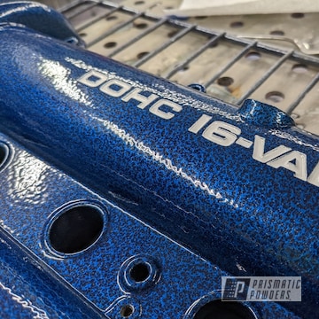 Miata Valve Cover Coated In Arctic White, Silver Artery And Booty Blue. Powder Coating Provides A Hard Finish That Is Tougher Than Conventional Paint.