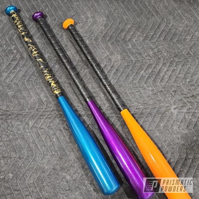 Baseball Bats Powder Coated In Hawaii Blue, Hawaiian Teal, Peacock Sapphire, Super Chrome Plus, Bright Orange And Illusion Violet